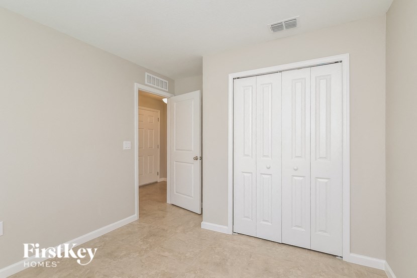 a bedroom with two closets and a door to a hallway