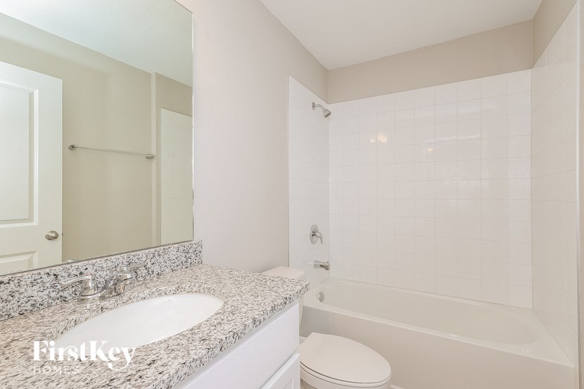 a bathroom with a sink and a toilet and a tub