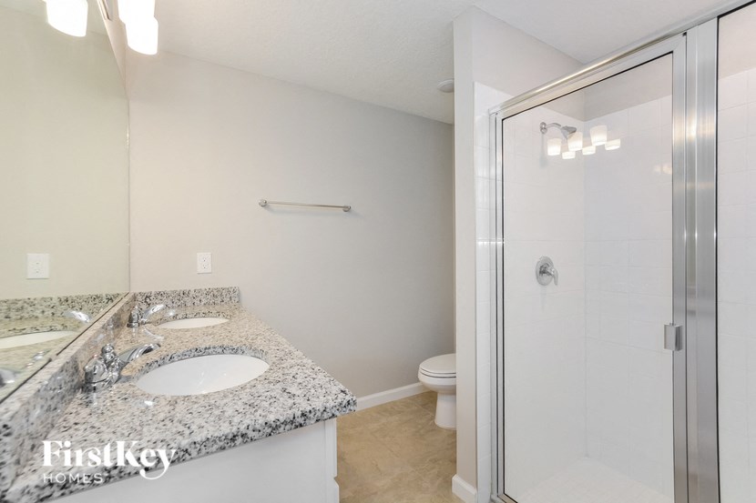 a bathroom with a sink and a shower and a toilet