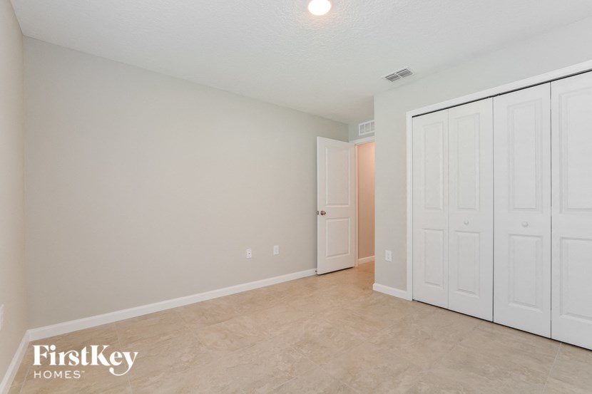 a bedroom with two closets and a door to a hallway