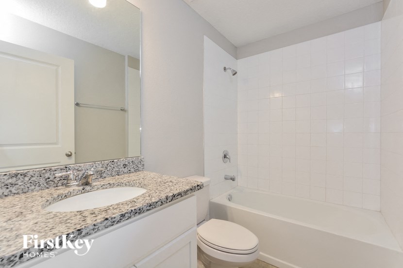 a bathroom with a sink and a toilet and a tub