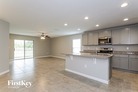 A kitchen with a countertop and cabinets is shown in a FirstKey Homes property.