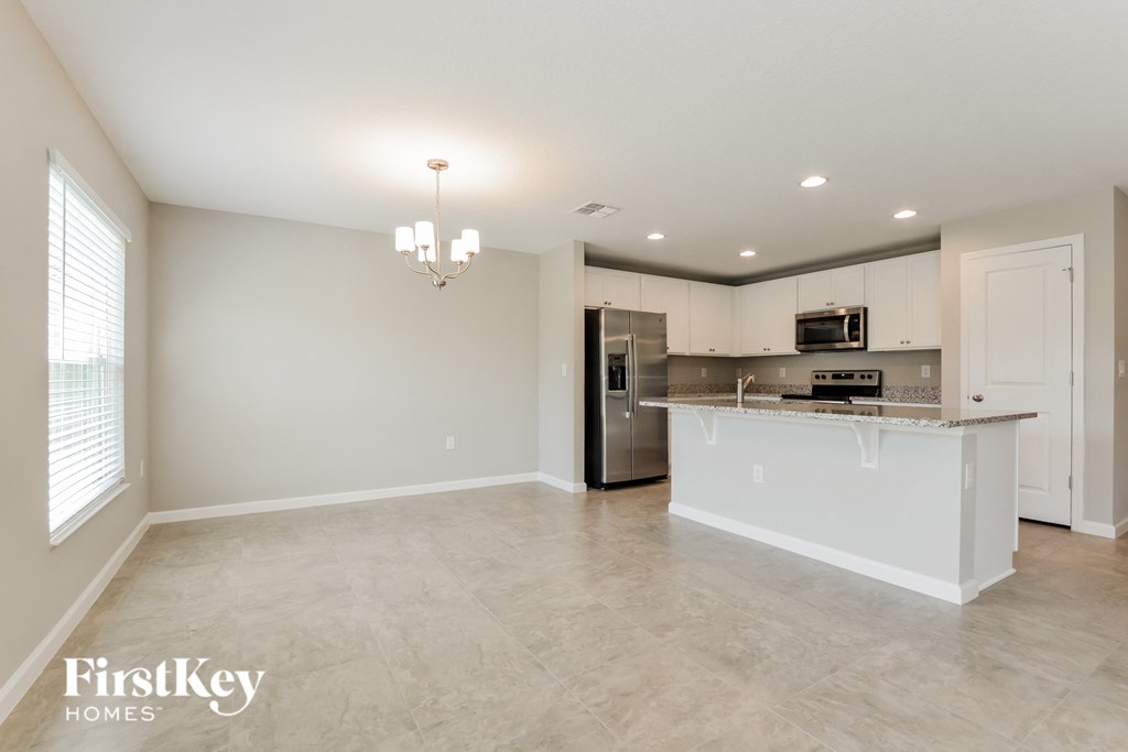 the kitchen is open to the living room and dining room