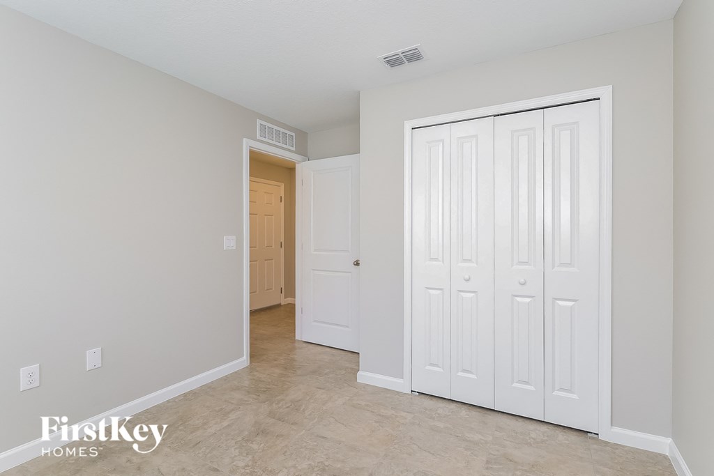 a master bedroom with two closets and a hallway with a door to a closet
