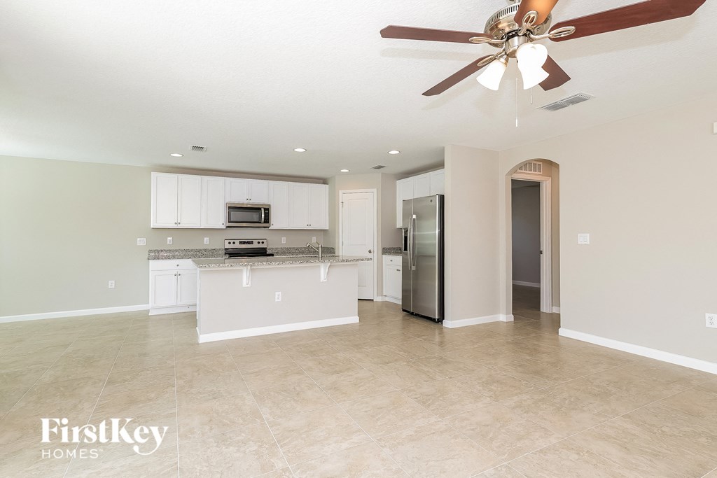 the kitchen and living room are spacious and clean