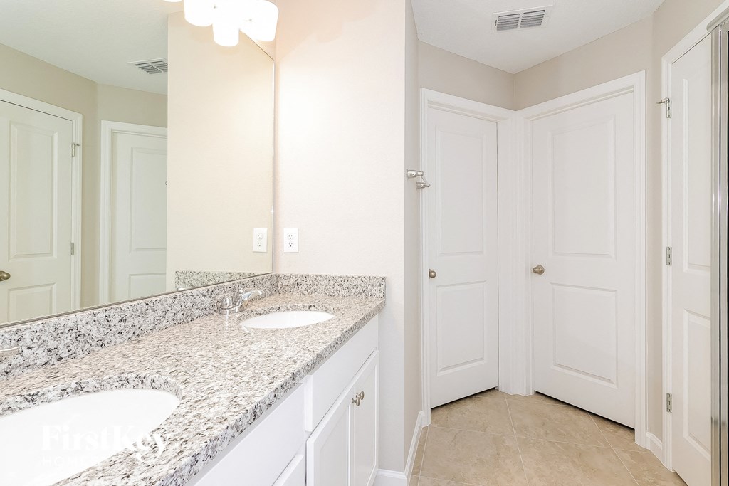 a bathroom with two sinks and a large mirror
