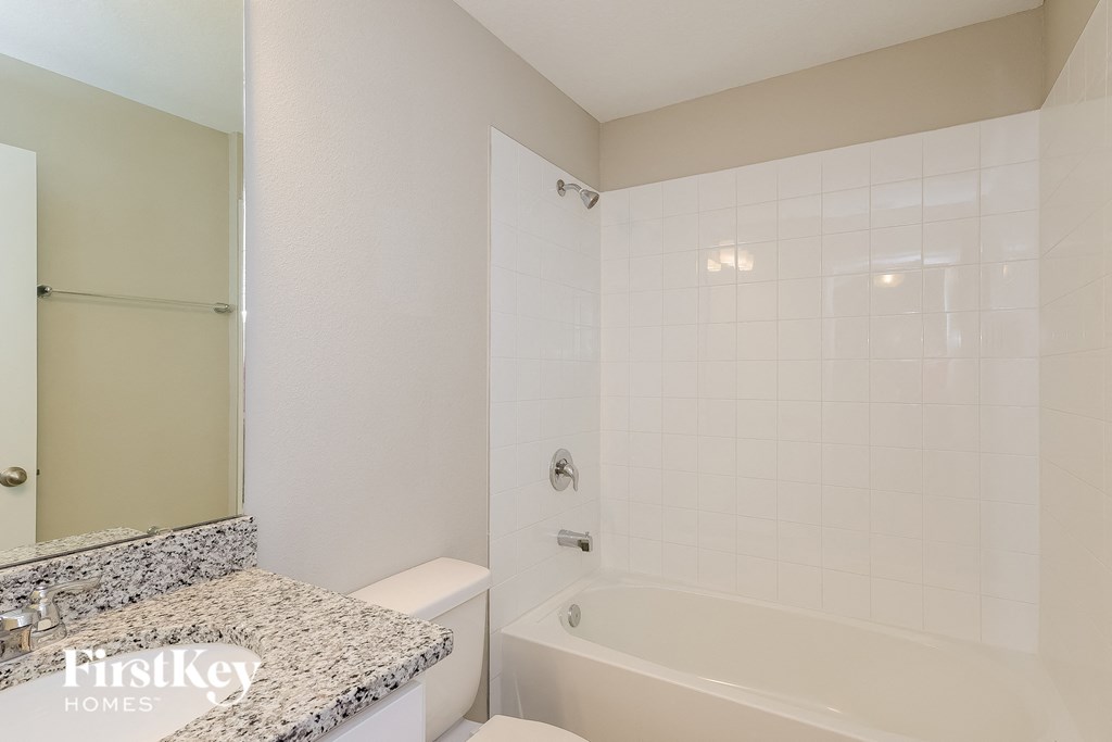 a bathroom with a tub and a sink and a toilet