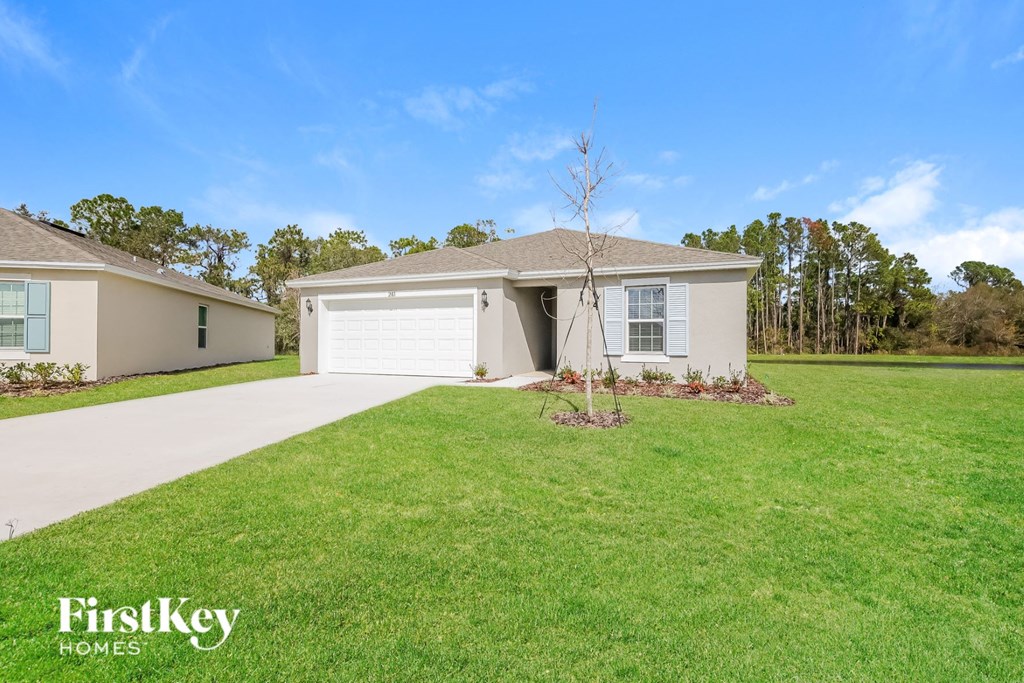 a beige house with a lawn and a white garage door