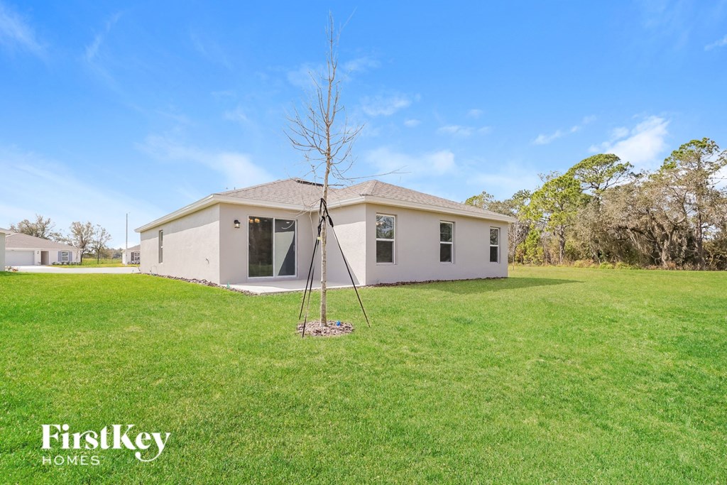 a small white house with a tree in the yard