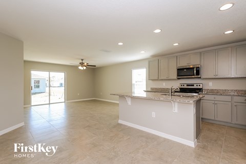A kitchen with a countertop and a microwave.
