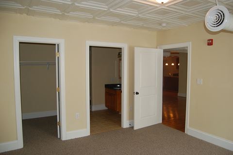 a living room with three doors and a closet