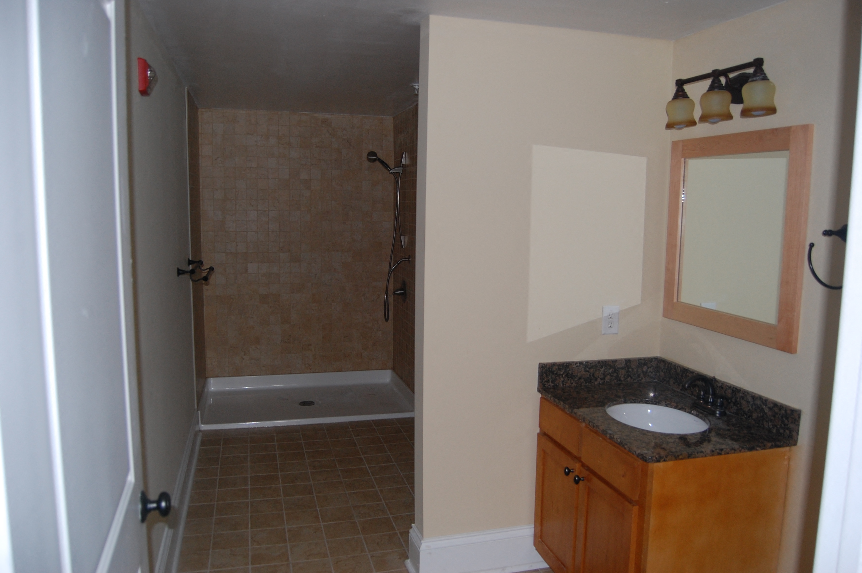 a small bathroom with a sink and a shower