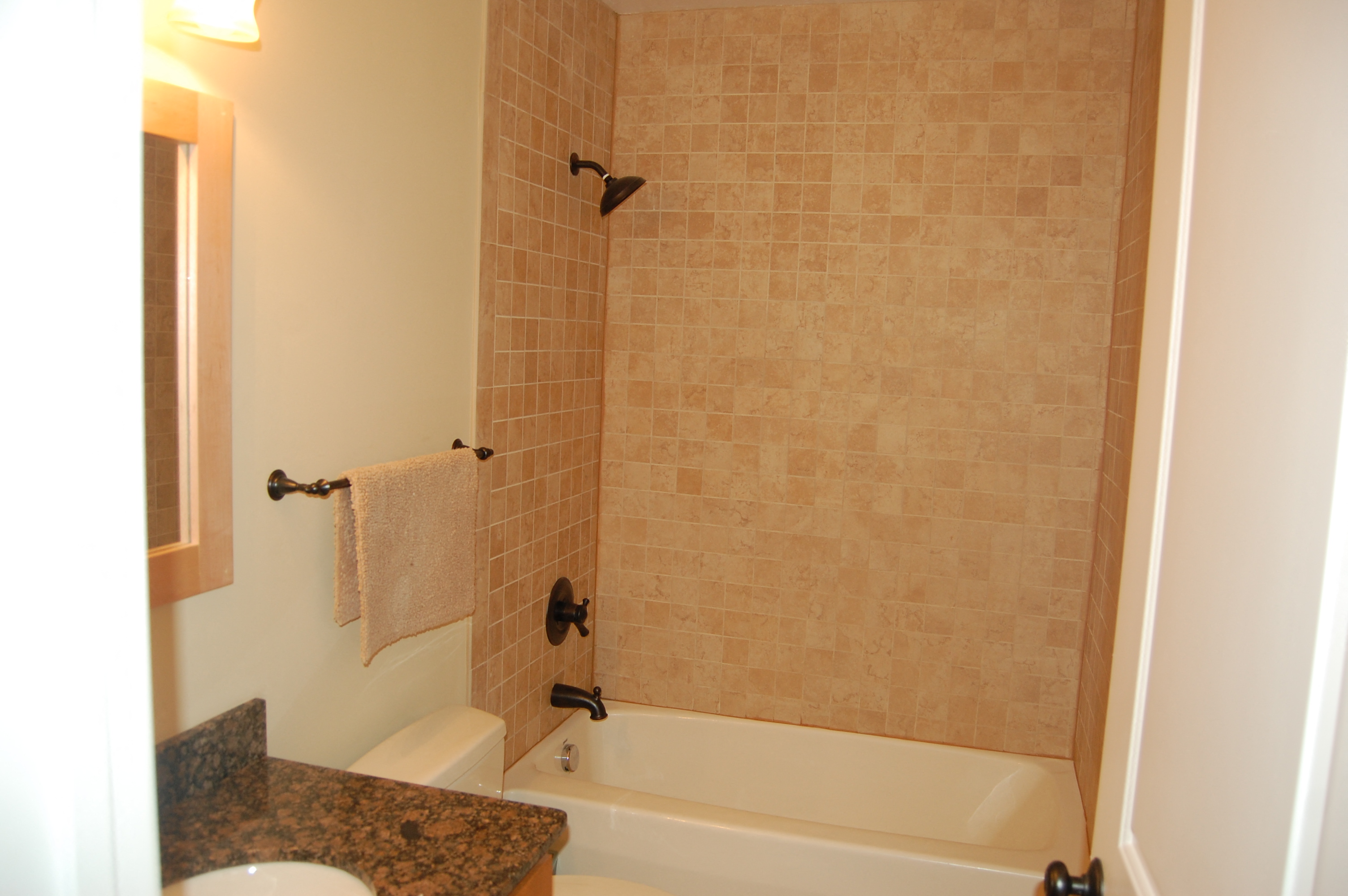 a bathroom with a tub and a sink and a toilet