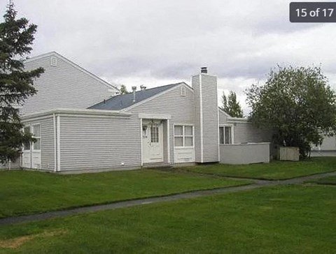 a white house on the side of a field