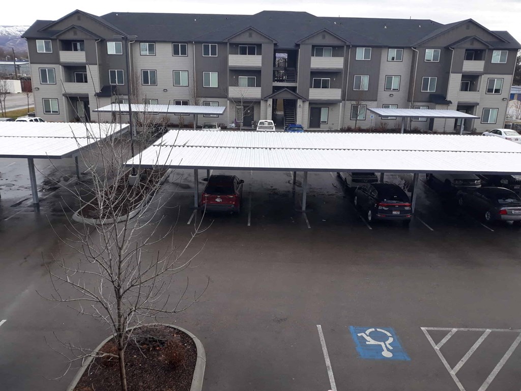 awning over a parking lot in front of an apartment building