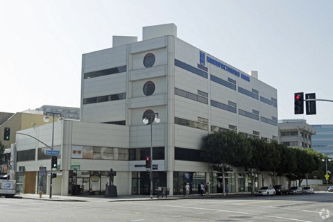 a large building on the corner of a city street