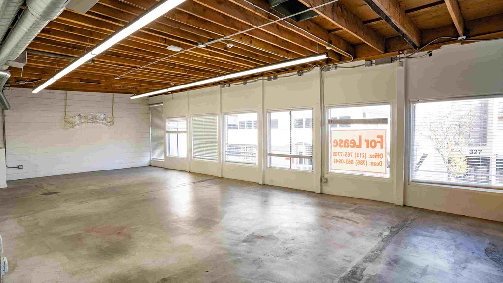 a large room with large windows and concrete floors