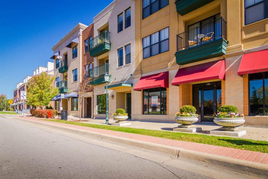 a row of apartment buildings on the side of a street