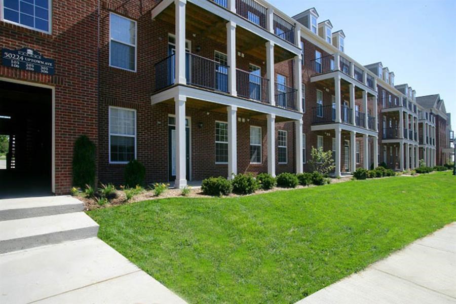 a brick building with a lawn in front of it