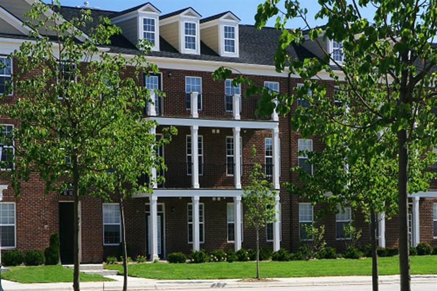 a large brick building with trees in front of it