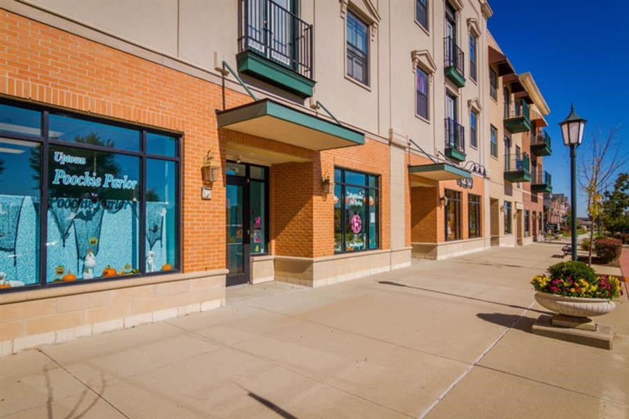 an empty sidewalk in front of a building