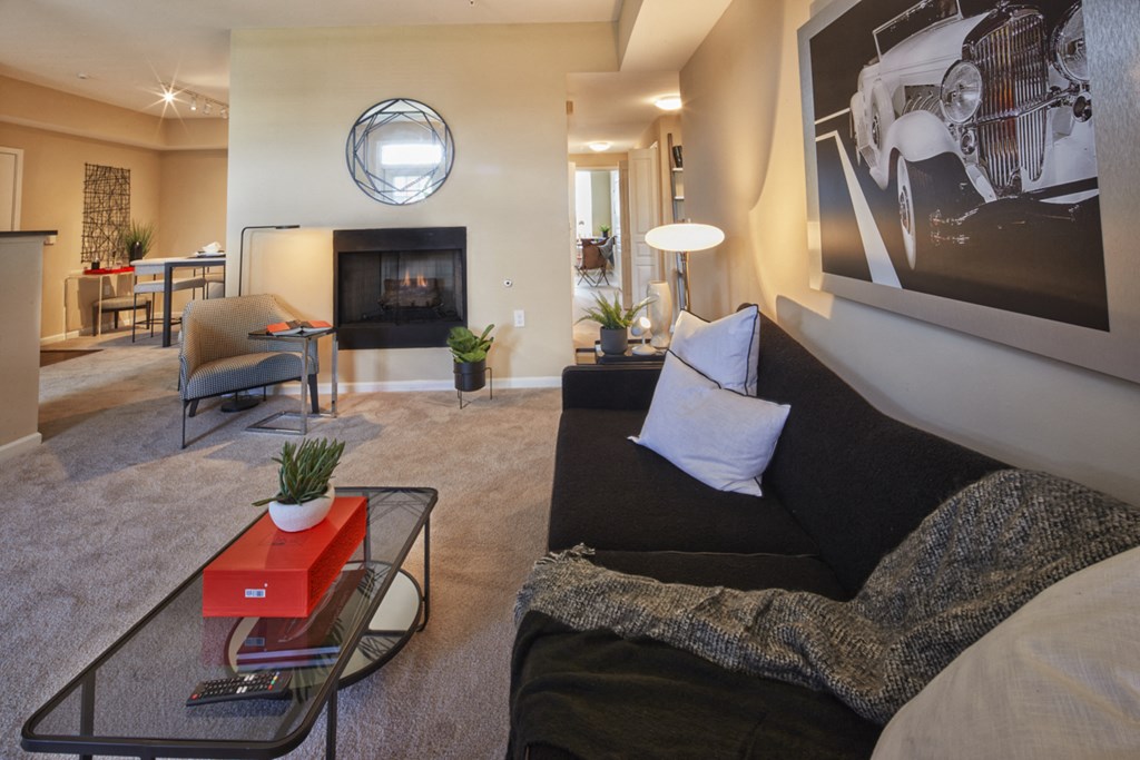 a living room with a couch and a coffee table and a fireplace
