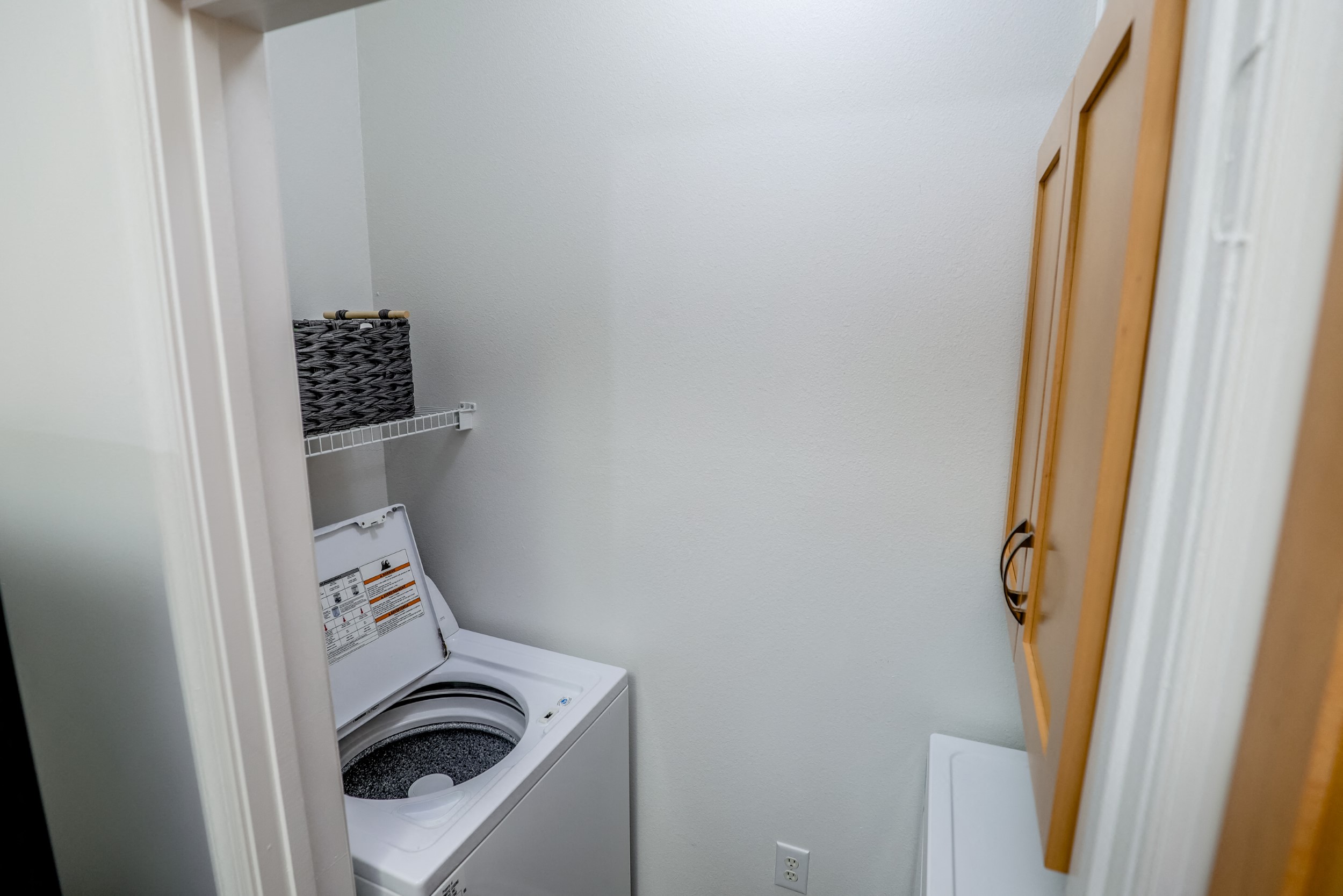 View of the laundry closet in the model home at Harbour Breeze Apartments in Suffolk Virginia