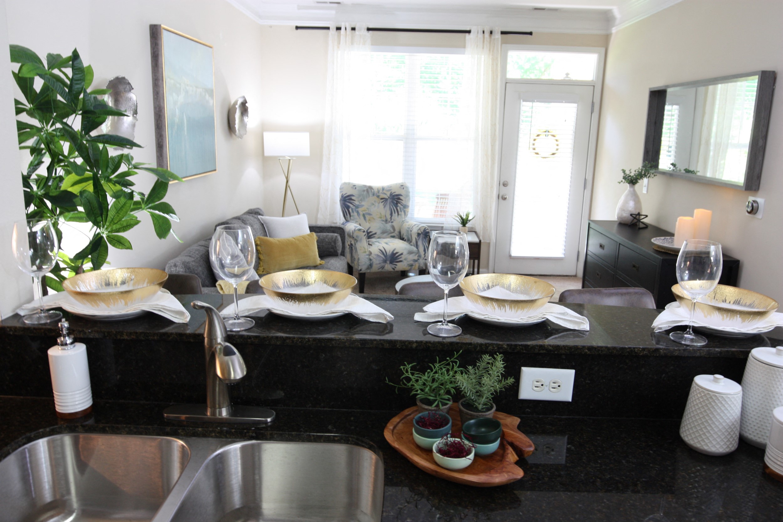 View of the living room from the kitchen in the model home at Harbour Breeze Apartments in Suffolk Virginia
