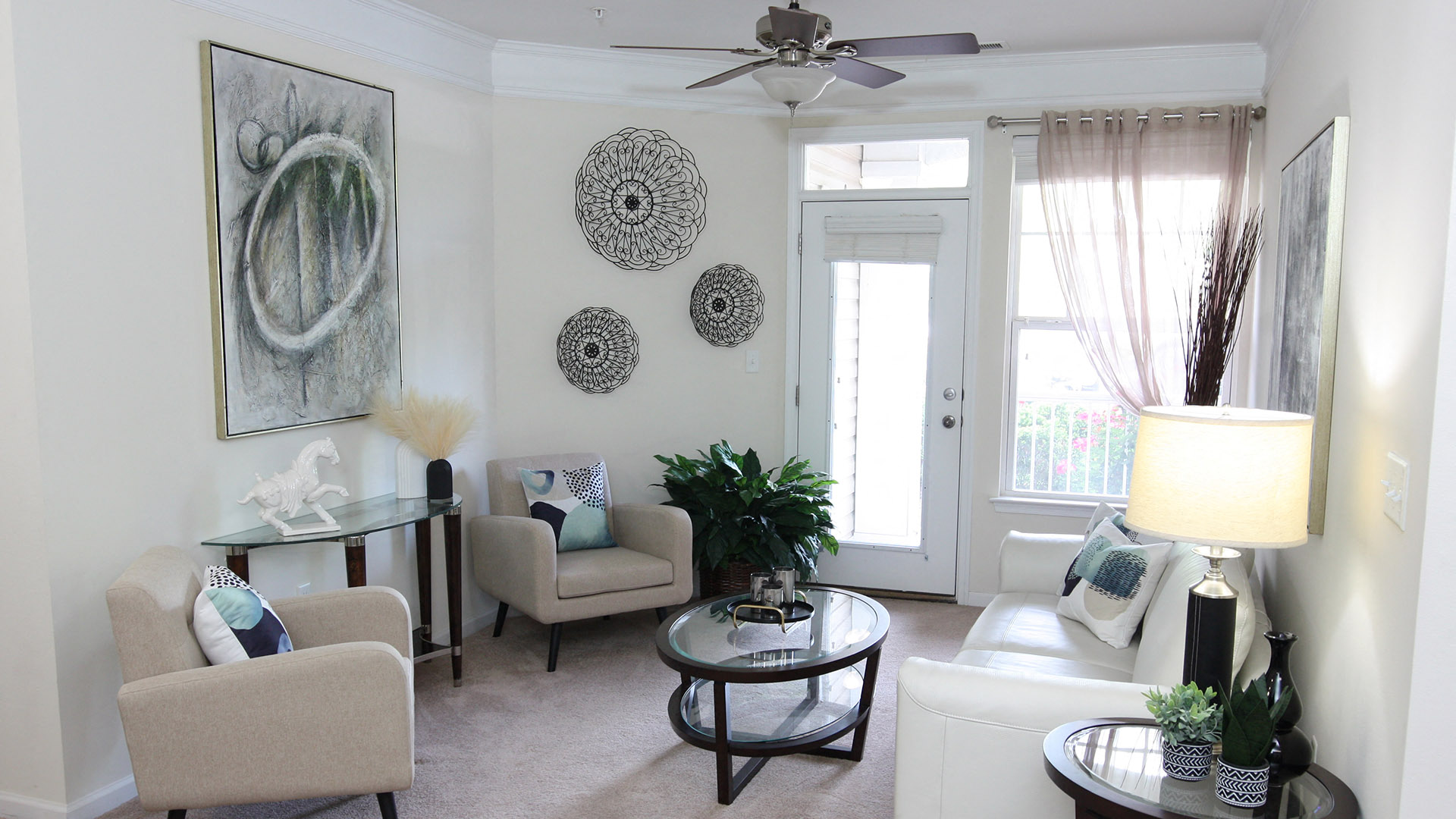 a living room with furniture and a ceiling fan