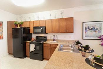 Fully-equipped chef's kitchens include built-in microwave, black appliances & granite countertops