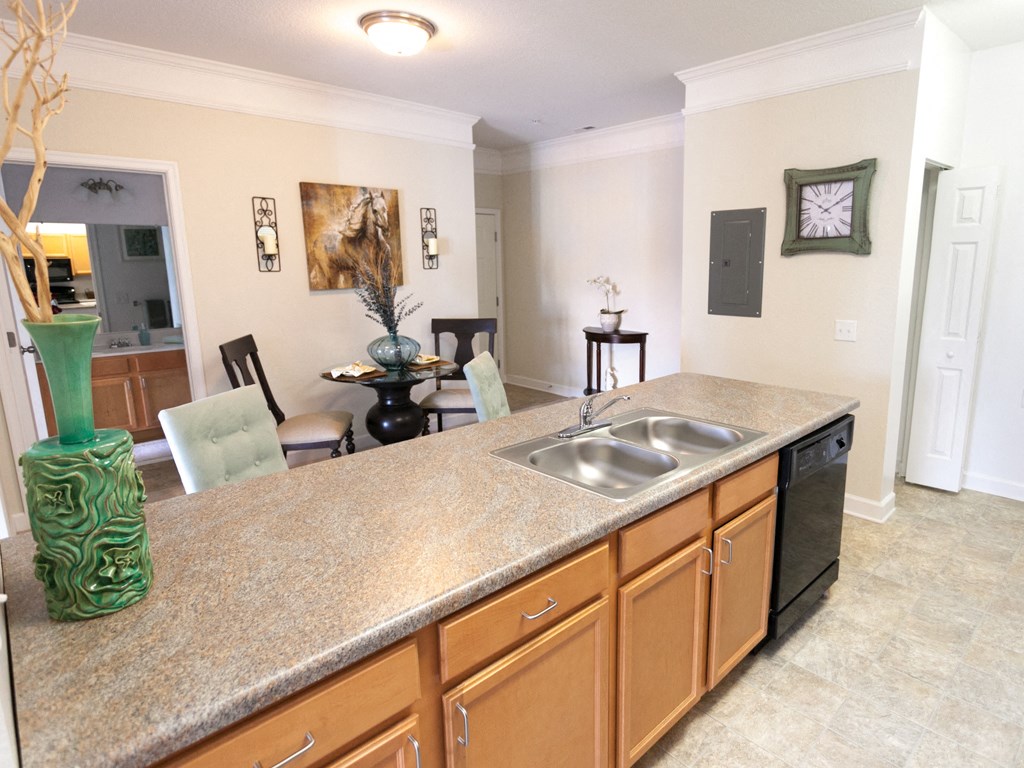 the view of a kitchen with a counter top and a sink
