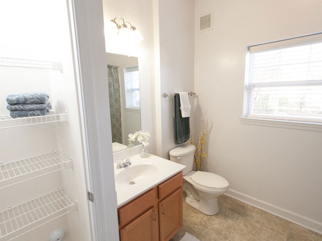 a bathroom with a sink toilet and a mirror