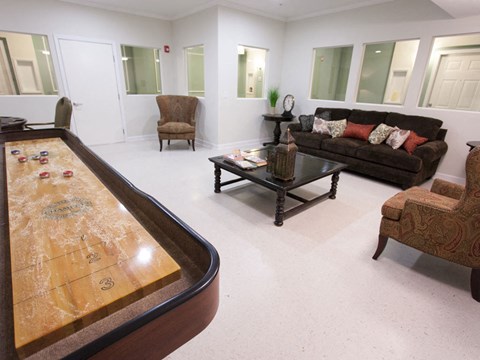 a living room with a pool table and couches