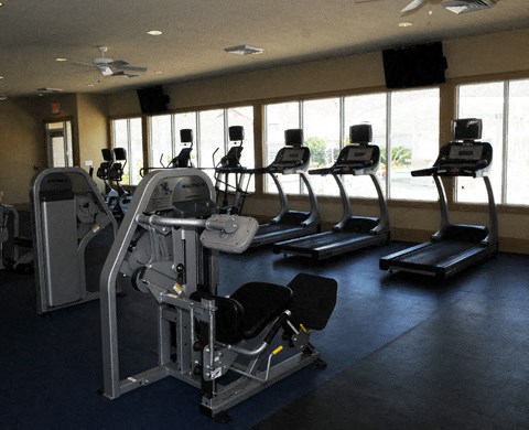 a gym with a bunch of exercise equipment in it