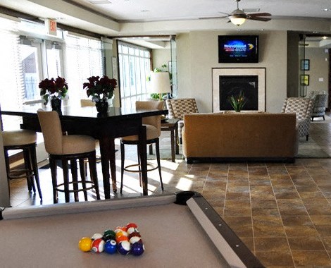 a living room with a pool table and a television