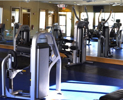 a gym with a bunch of exercise equipment in it