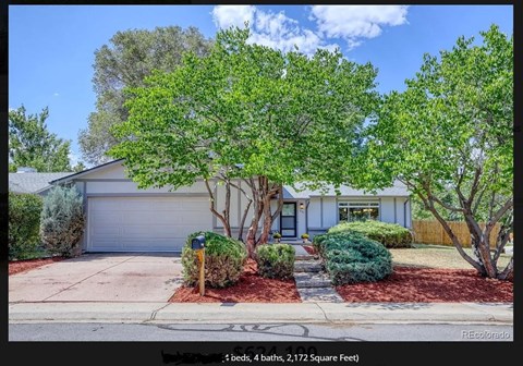 a house with a tree in the front of it