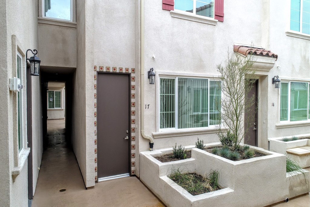 the entrance to an apartment building with a brown door