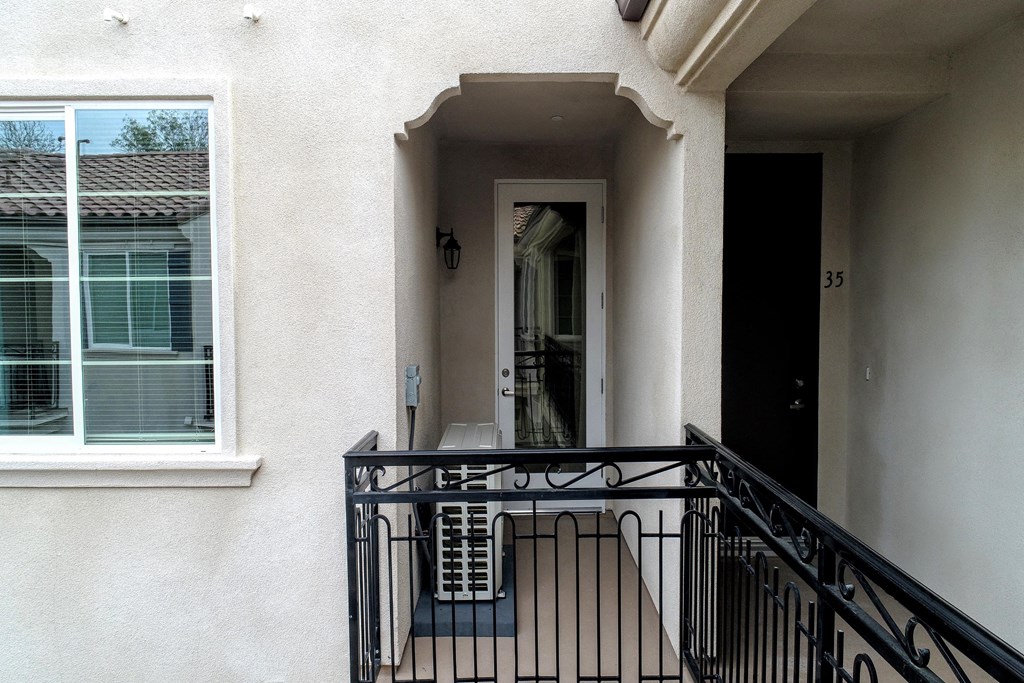 the front door of a house with a balcony