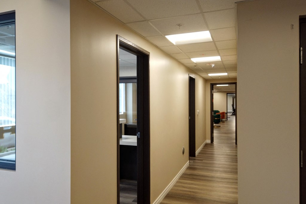 a hallway of mirrors in an office building