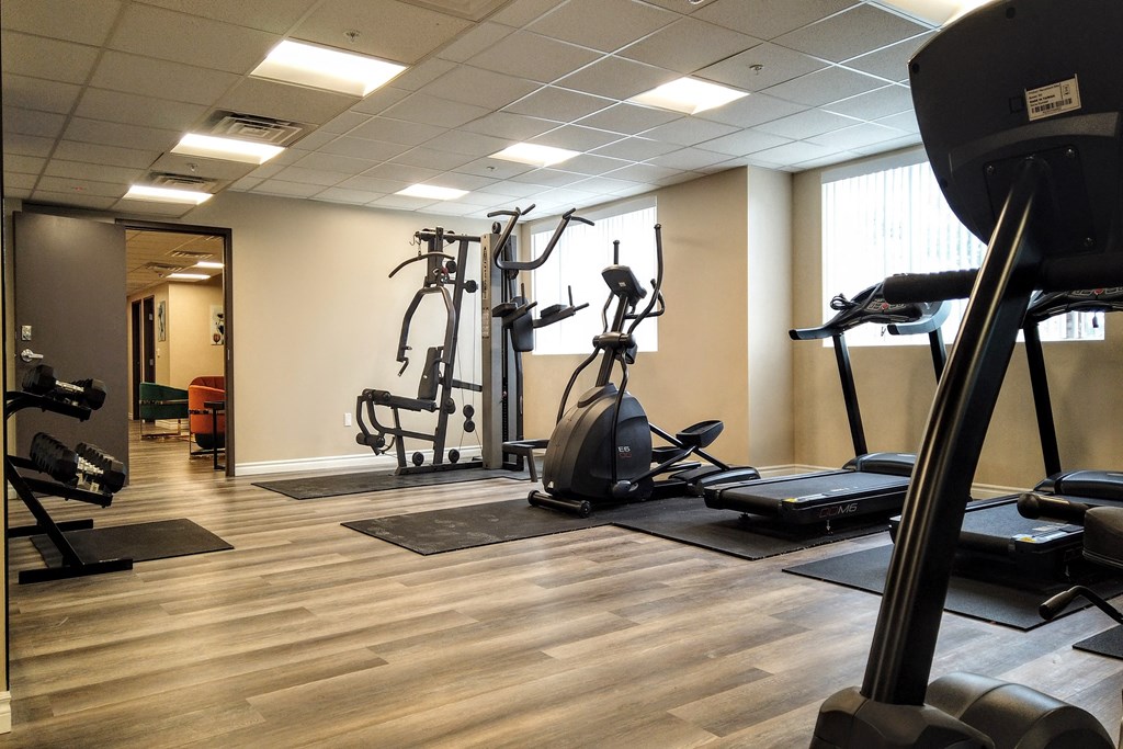 a gym with cardio machines and other exercise equipment