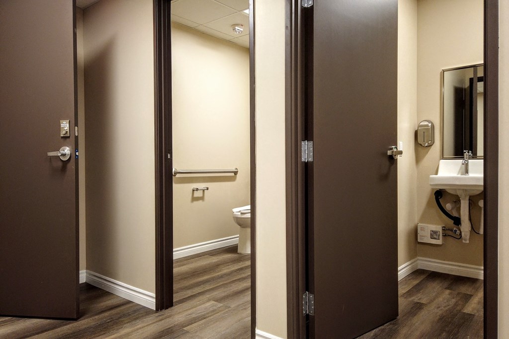 a bathroom with a toilet and a sink and a mirror