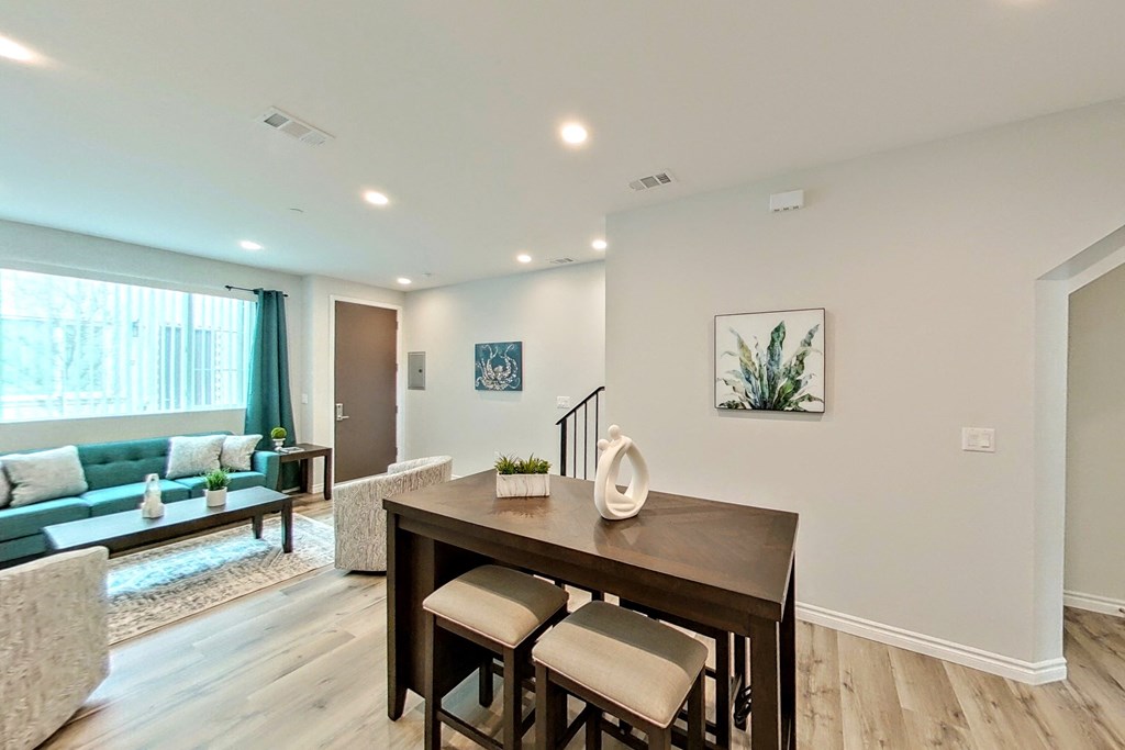 a dining room and living room with a table and chairs