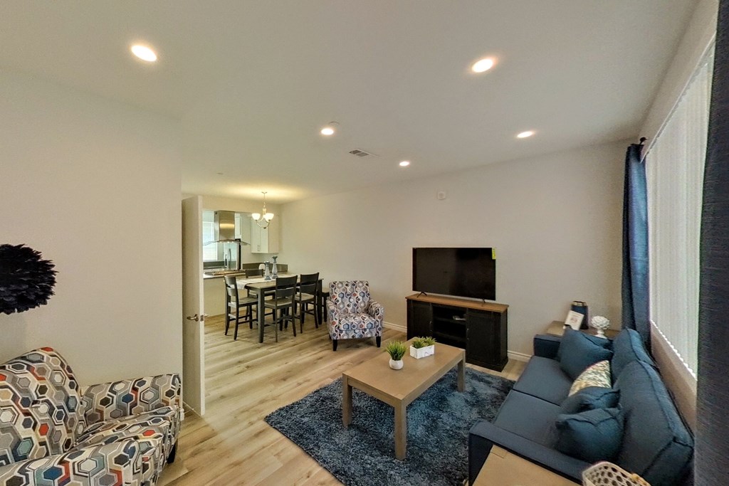 a living room with a couch and a table and a television