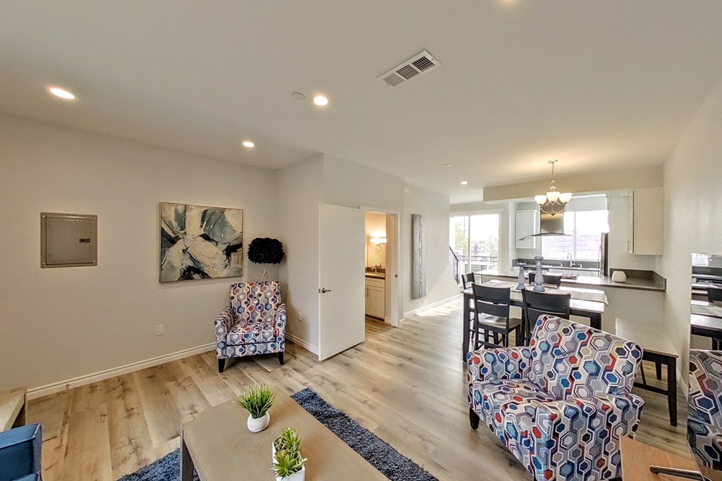 a living room and dining room with furniture and a kitchen