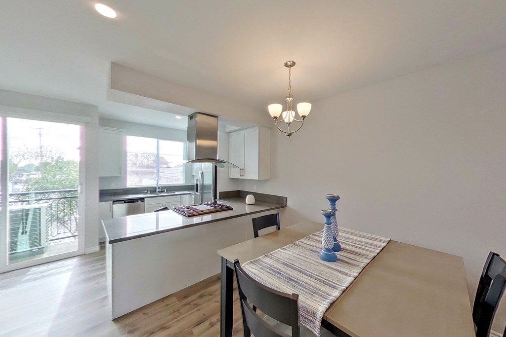 a dining room with a table and a kitchen
