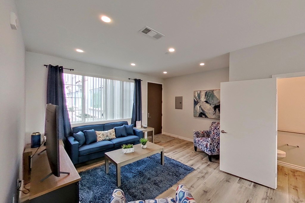 a living room with a blue couch and a coffee table