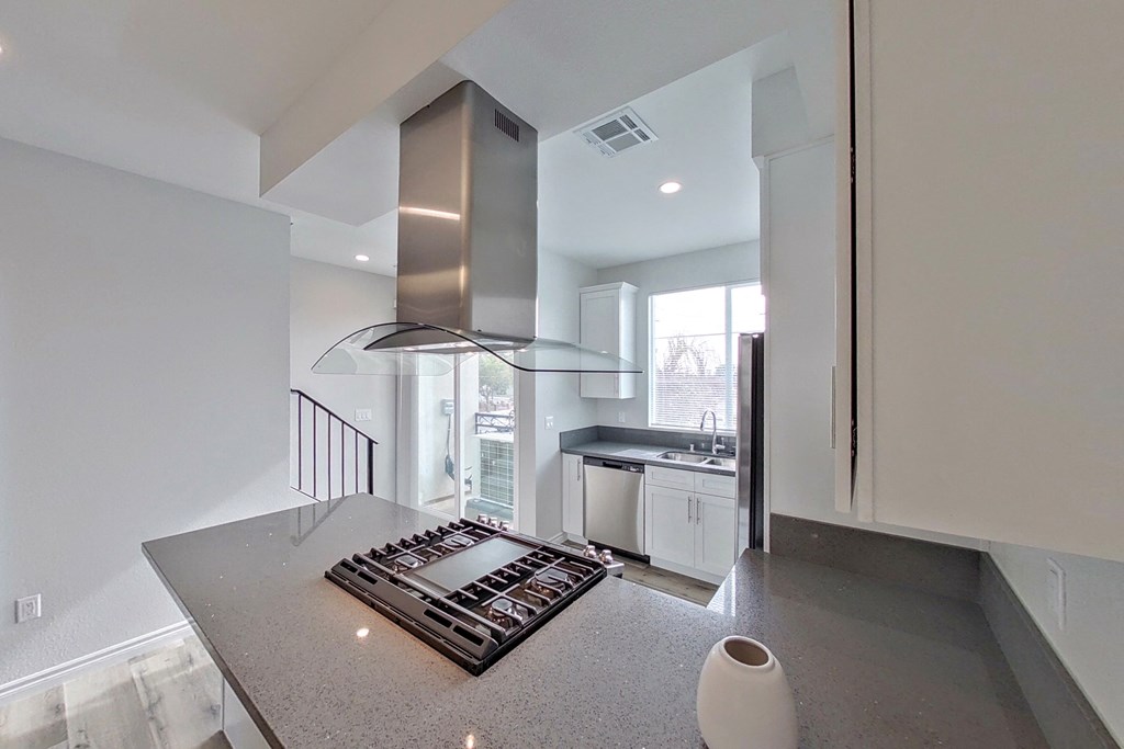 a kitchen with a stove and a sink in a house