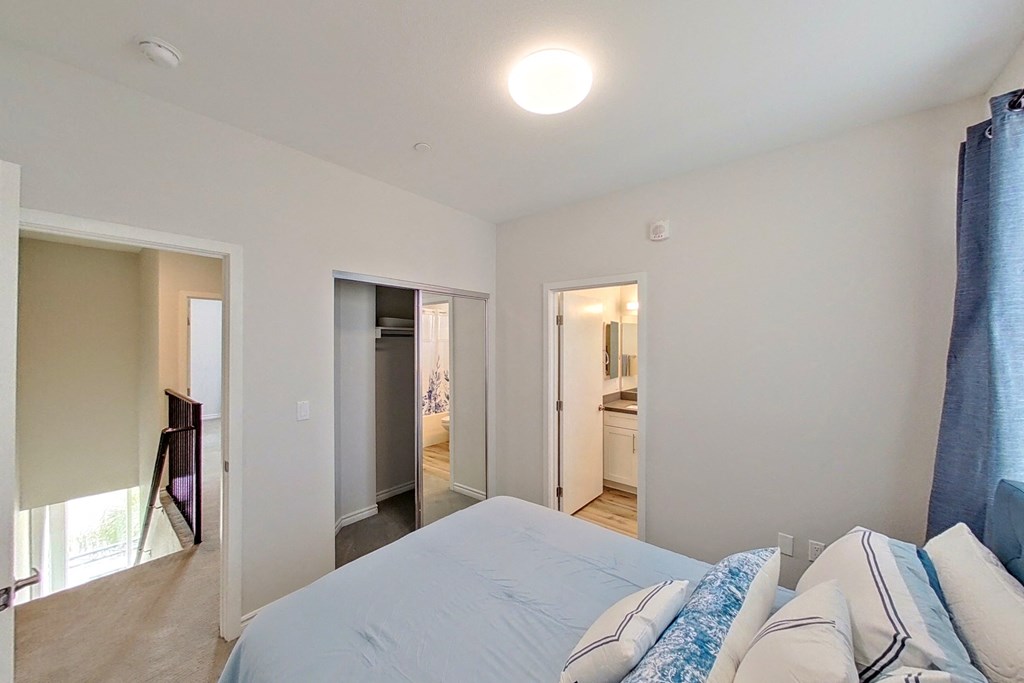 a bedroom with a bed and a door to a bathroom