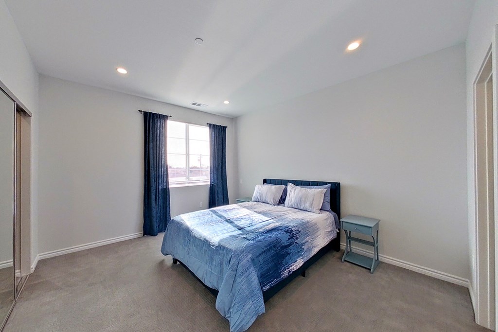 a bedroom with a bed and a window